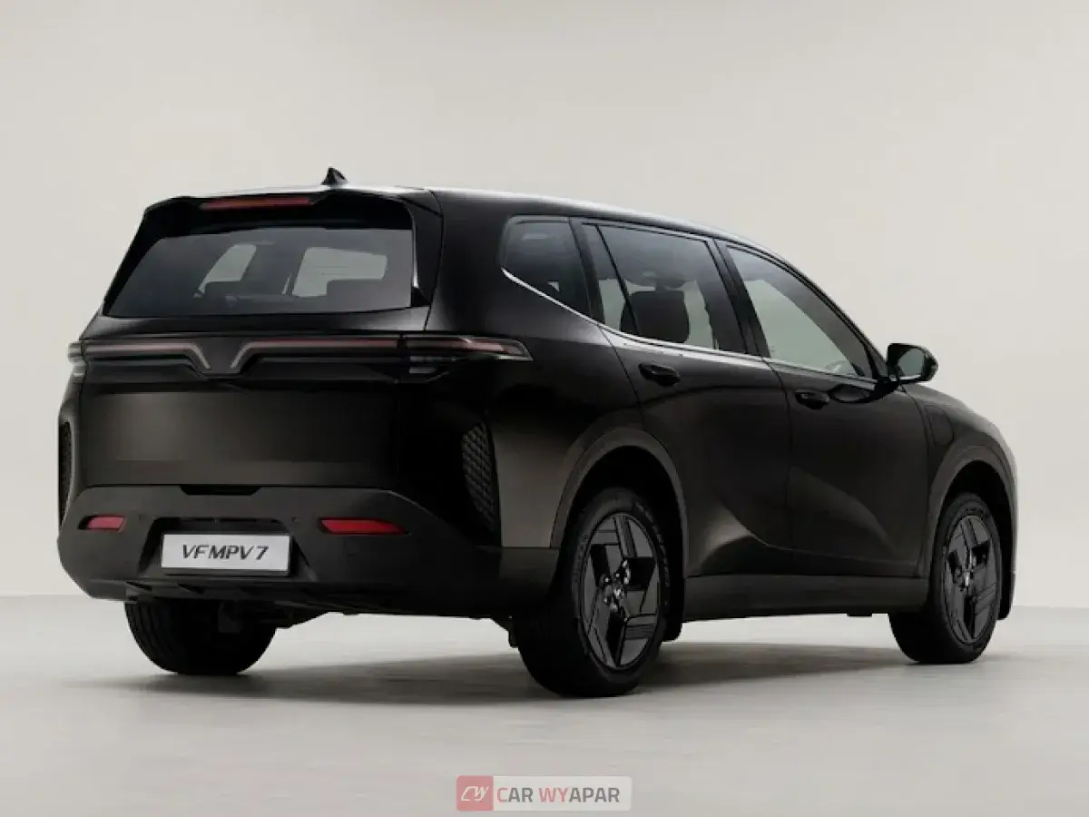 Rear three-quarter view of a dark grey SUV parked in a studio.